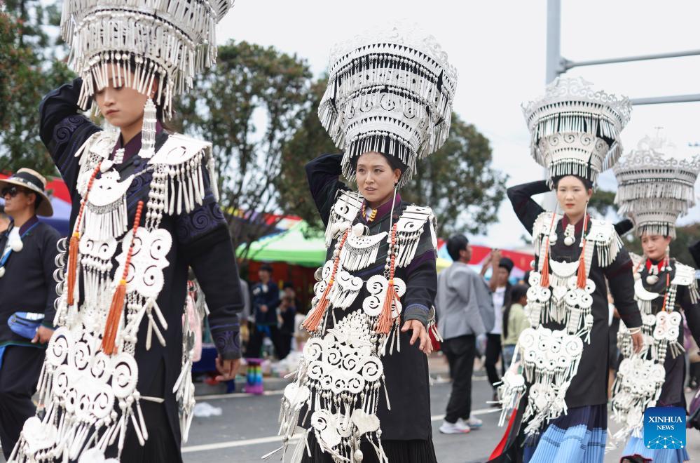 People dressed in traditional Yi costumes celebrate torch festival in China