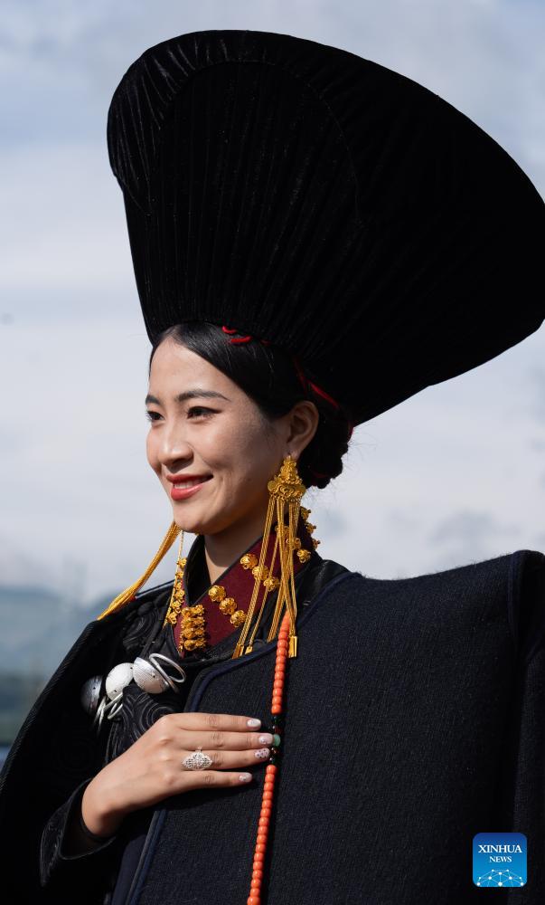 People dressed in traditional Yi costumes celebrate torch festival in China