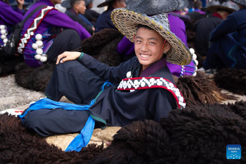 People dressed in traditional Yi costumes celebrate torch festival in China