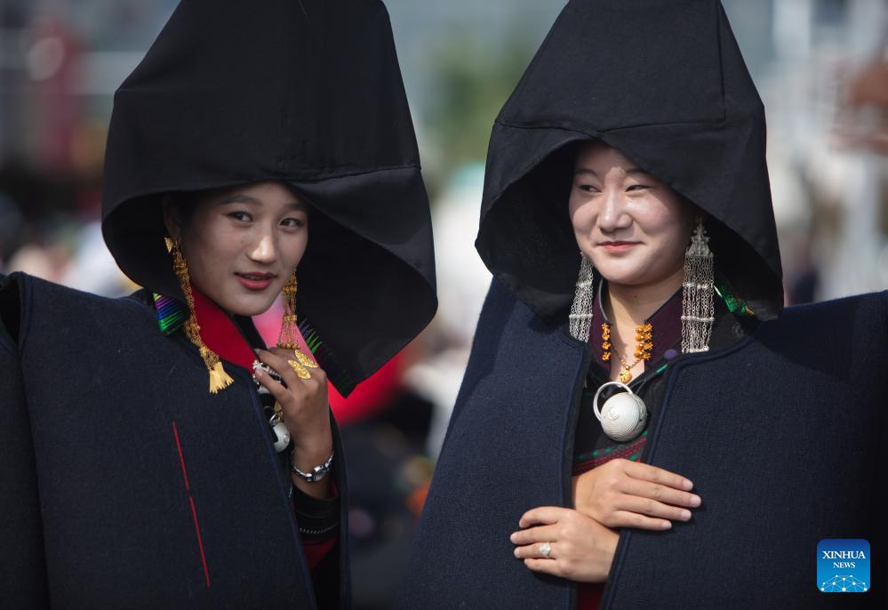 People dressed in traditional Yi costumes celebrate torch festival in China