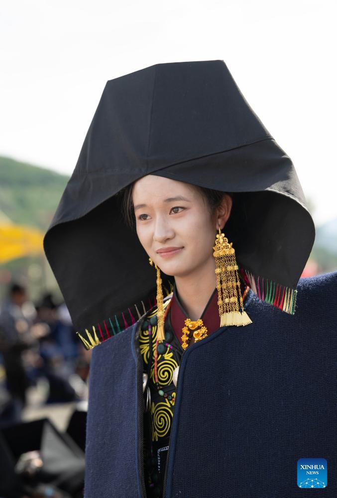 People dressed in traditional Yi costumes celebrate torch festival in China