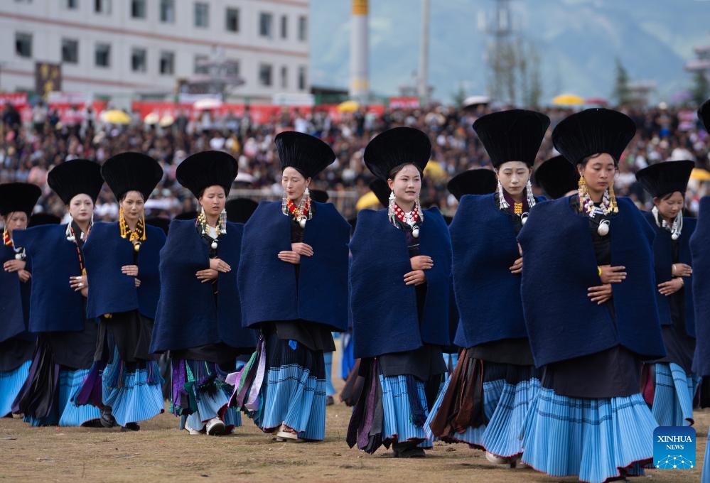 People dressed in traditional Yi costumes celebrate torch festival in China