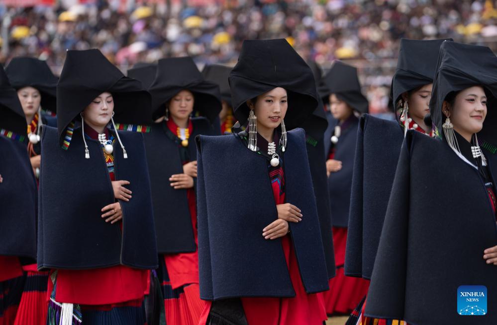 People dressed in traditional Yi costumes celebrate torch festival in China