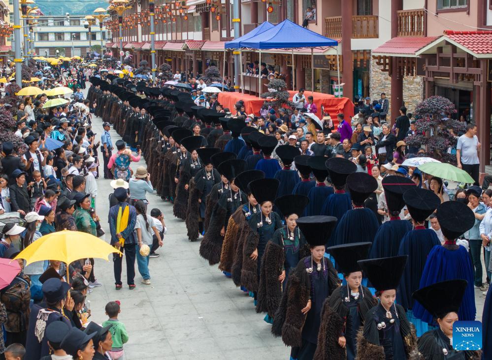 People dressed in traditional Yi costumes celebrate torch festival in China