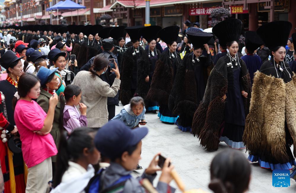People dressed in traditional Yi costumes celebrate torch festival in China